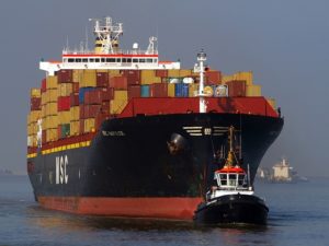 Tugboat with cargo ship, marine insurance, Allen Insurance and Financial