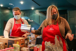 Valerie Robinson and Jen Fifield sort food donations at the Strand as part of the AIO food drive on Jan. 18