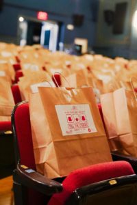 Seats at The Strand Theatre, Rockland, Maine, filled with bags of food